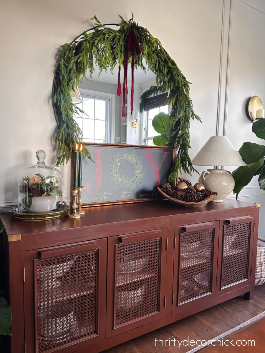 round mirror over dining buffet